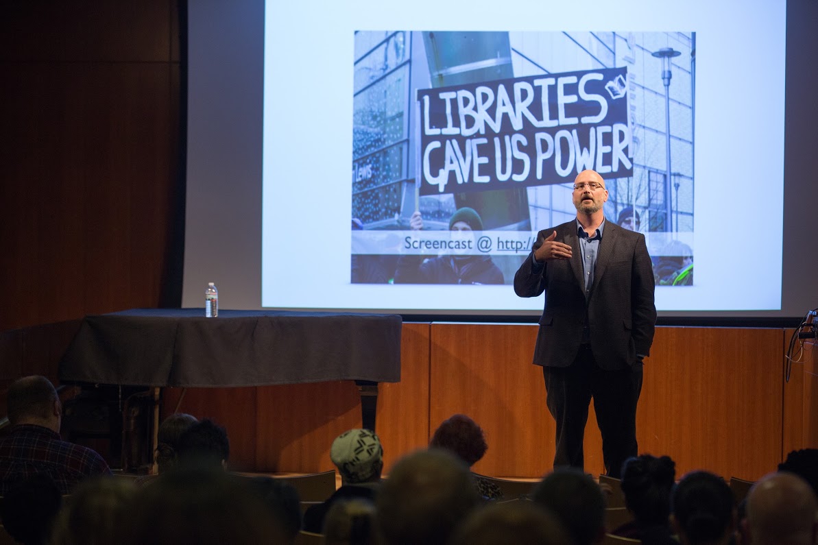 R. David Lankes delivers his keynote, in front of a libraries gave us power sign