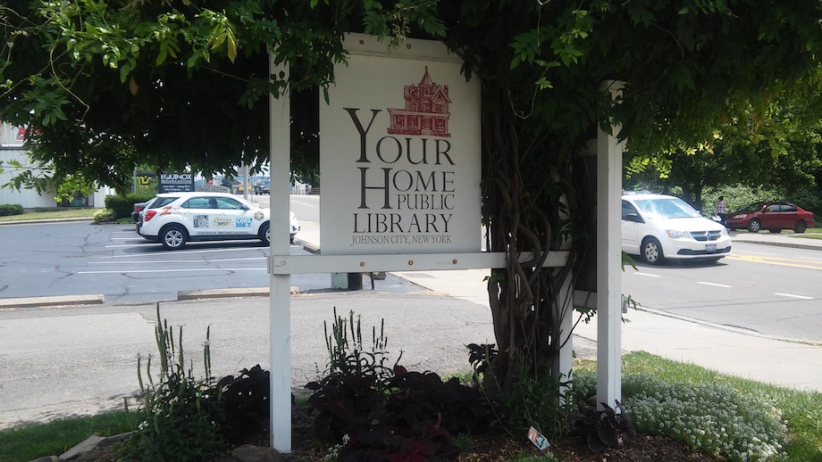 your home public library sign on front lawn