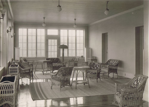 reading room with magazines, chairs, and stacks in the sun porch side of the building